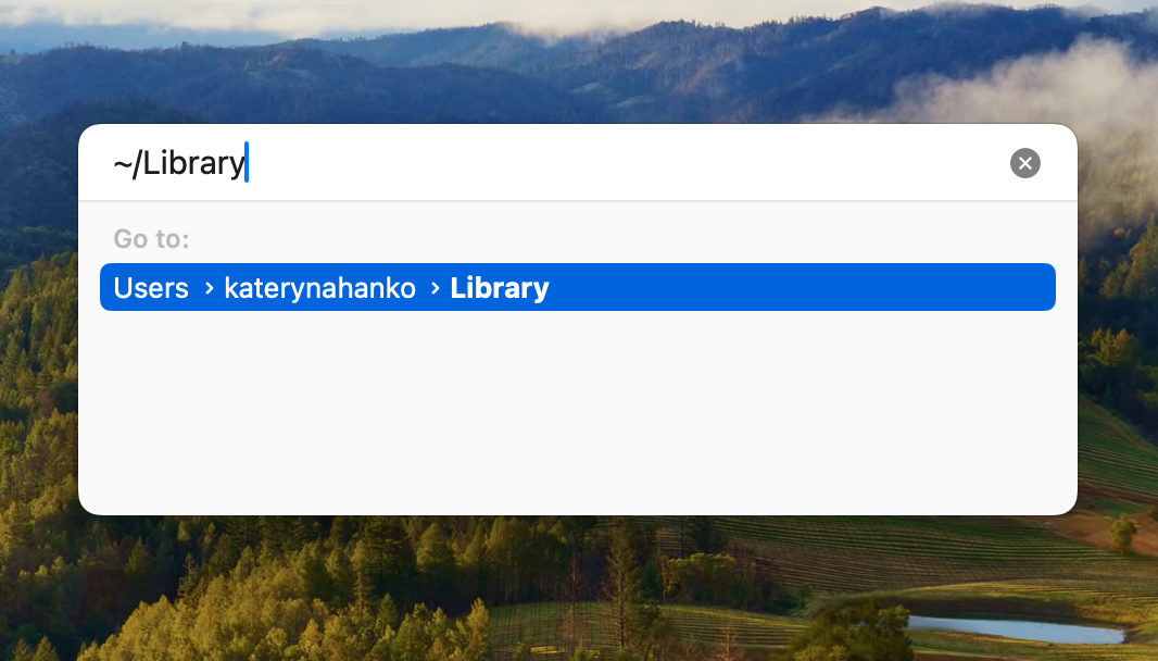 A screenshot of the Go to Folder window showing how to type ~/Library and press Enter to remove malware from Mac. A screenshot of the Go to Folder window showing how to type ~/Library and press Enter to remove malware from Mac.