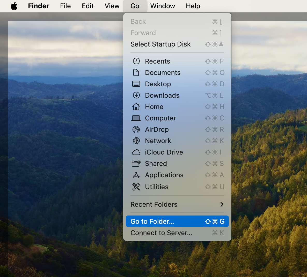 A screenshot of the Go drop-down menu showing how to select Go to Folder to remove malware from Mac. A screenshot of the Go drop-down menu showing how to select Go to Folder to remove malware from Mac.