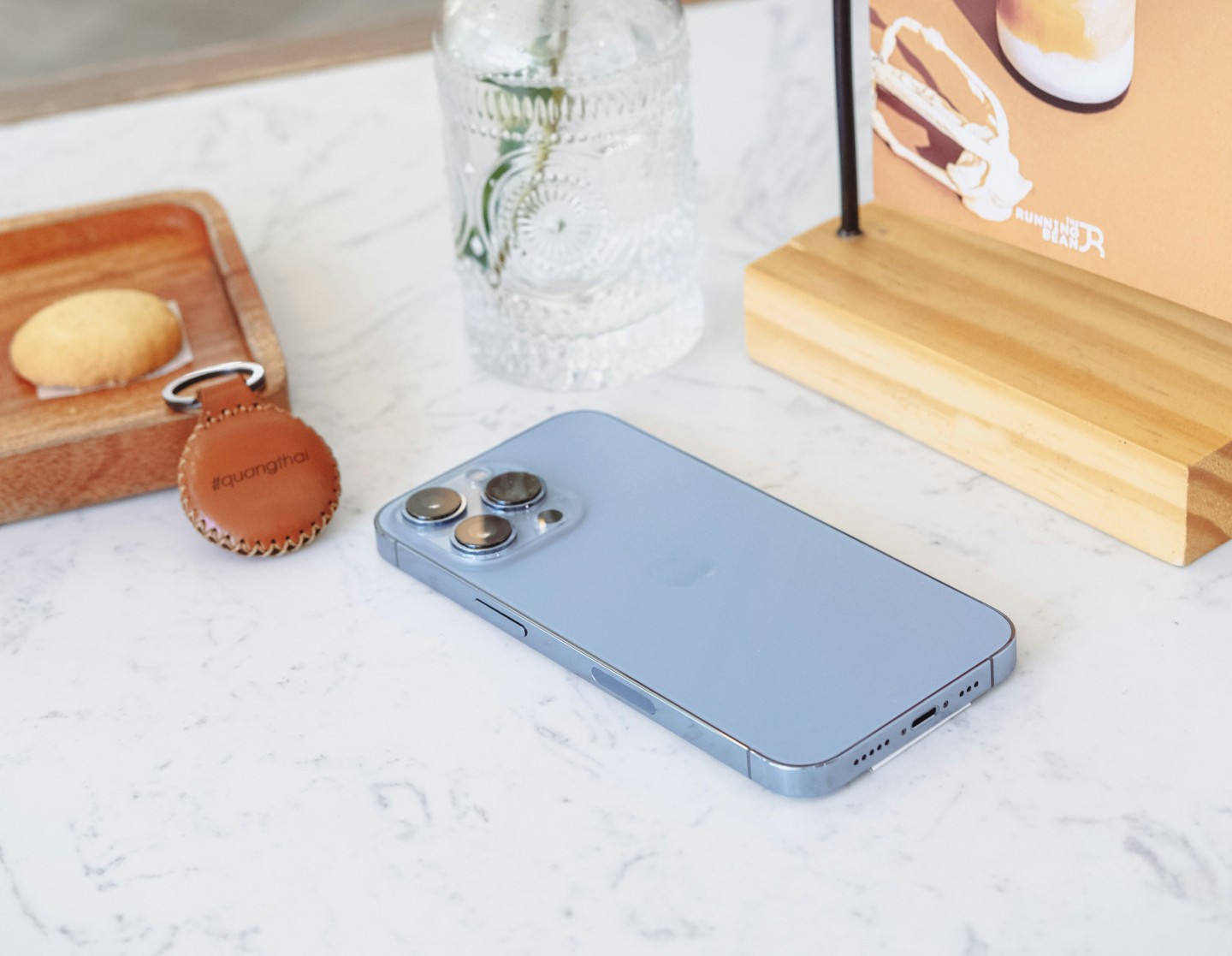 AirTag placed within a few inches of an iPhone during setup to ensure successful Bluetooth pairing.